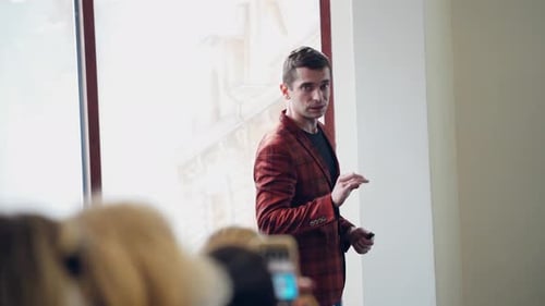 Man Speaker Teaching Public in the Hall