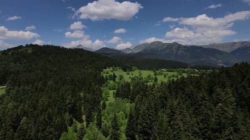 Aerial View of Green Valley and Distant Mountains