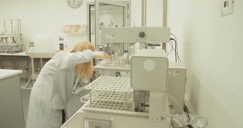 Scientist Working with Lab Equipment in Clean Setting