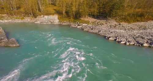 Low Altitude Flight Over Fresh Fast Mountain River with Rocks at Sunny Summer Morning.