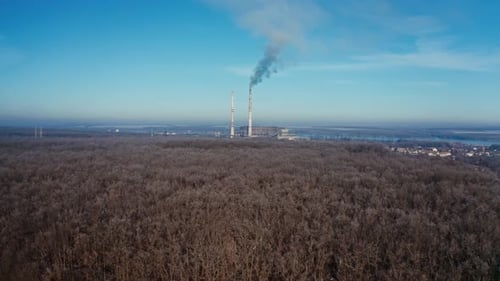 Landscape with smoked polluted atmosphere. Aerial view of high chimney pipes with grey smoke