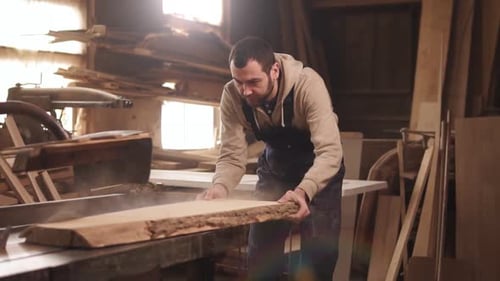 Caucasian Man is Working in His Workshop