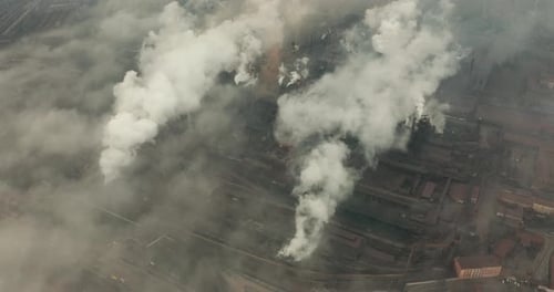 Epic Aerial of High Pipes with Smoke Emission. Plant Pipes Pollute Atmosphere. Industrial Factory