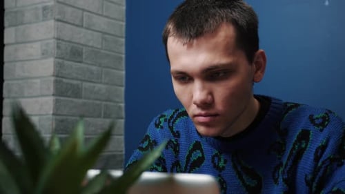 Young Man Using Tablet Device Indoors