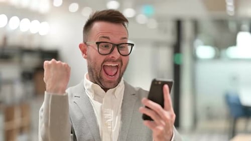 Man Reacts to Good News on His Phone