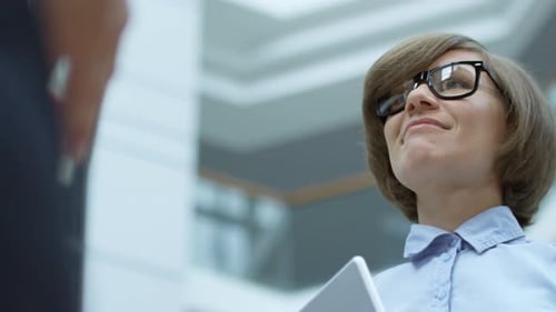 Businesswoman Holding Tablet in Bright Office Environment