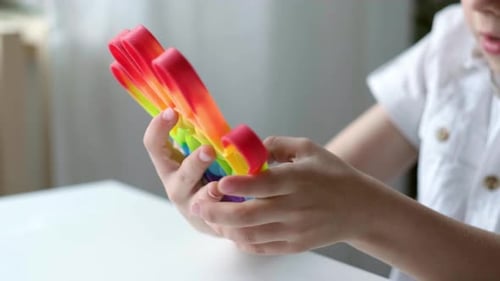 Child Play with Pop It Sensory Toy