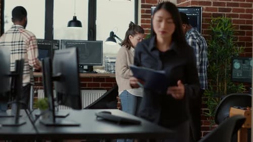 Software Developer Holding Digital Tablet Analyzing Code on Wall Screen Tv Explaining Errors to