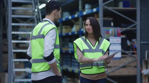 Warehouse Employees Review Inventory Information Together