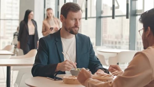 Male Colleagues Having Lunch at Food Court