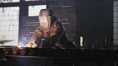 Industrial Worker Welding Metal with Safety Mask
