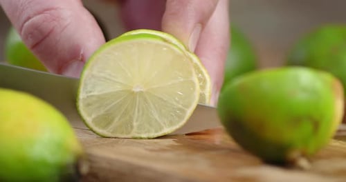 Slicing Fresh Lime on a Wooden Board