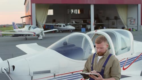 Aircraft Mechanic Working with Tablet Computer