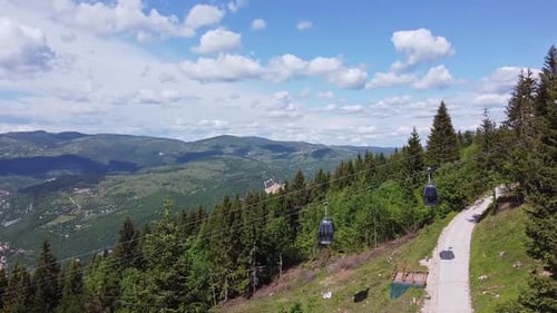 Cable Cars Ascend Lush Green Mountain Landscape