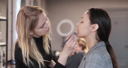 Makeup Artist Applying Foundation to Model
