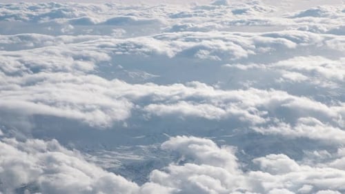 Airplane Flying Above Clouds
