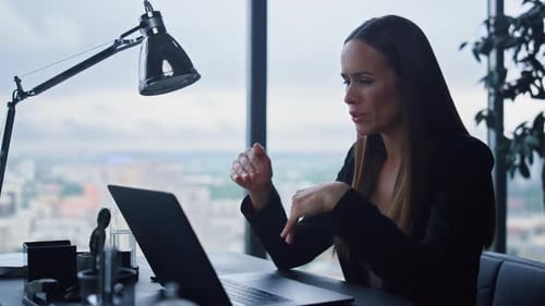 Attractive Businesswoman Talking with Business Partner on Video Chat in Office
