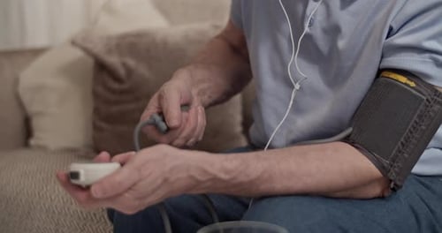 Man Taking Blood Pressure at Home Close Up