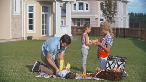 Family Enjoys Picnic on the Lawn
