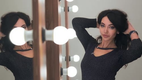 Glamorous Woman Posing in Front of Mirror