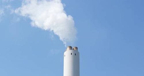 Factory plant smoke stack on blue sky