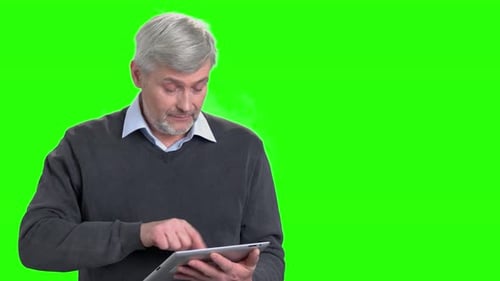 Mature Man Using Tablet on Green Screen