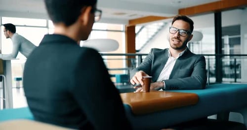 Businessmen Discussing Business Over Coffee at Modern Office