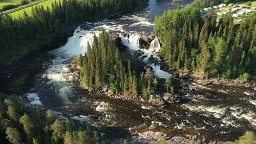 Scenic Waterfall Flowing Through Green Forest Landscape