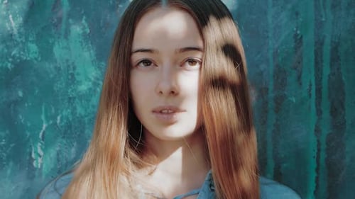 Young Woman Posing by Graffiti Wall