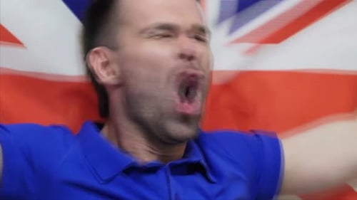 Enthusiastic Man Cheering in Front of British Flag