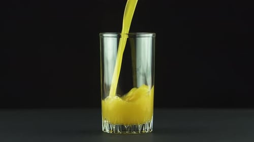 Pouring Refreshing Orange Juice into Glass