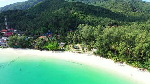 Wide angle overhead travel shot of a sandy white paradise beach and aqua blue water background in co