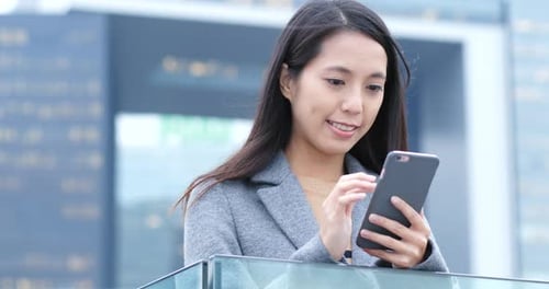 Woman Using Smartphone in an Urban Environment