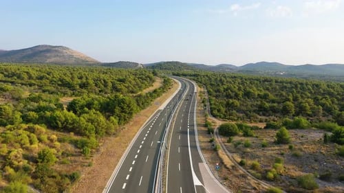 Aerial view on road. Highway through mountain valley. View from a drone.