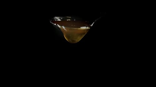 a Drop of Golden Honey Dripping From the Spoon