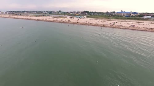 Aerial Shot of Black Sea Beach with Tourists, Sunshades, Hotels and Greenery