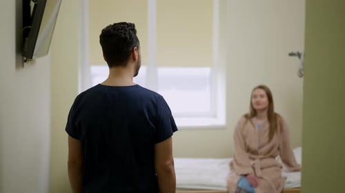 Live Camera Follows Confident Middle Eastern Doctor Entering Hospital Ward with Caucasian Patient