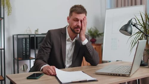 Stressed Business Man Worried About Financial Paperwork Problem Money Debt Budget Loss at Office