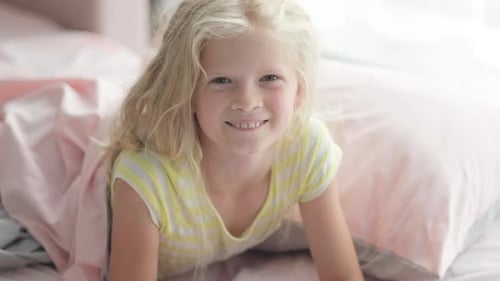 Happy Blonde Girl Smiling in Bed