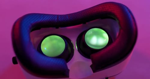 Virtual reality device with video playing inside under purple lighting