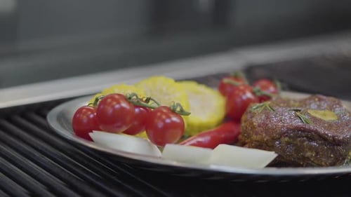 The Plate with the Meat, Corn, Cherry Tomatoes, Lemongrass and Chili Pepper Lying on the Grill
