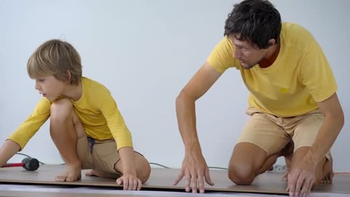 Father and Son Laying Flooring Together