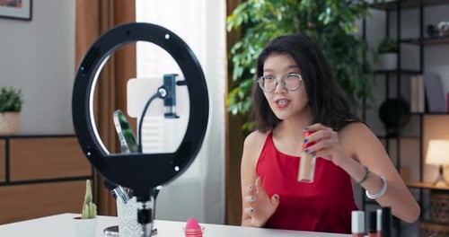 A Popular Influencer Vlogger Creates a Video on Social Media Talking Into Phone Set Up on Ring Light
