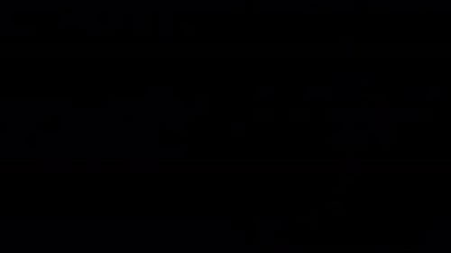 Colorful Animated Specks Floating on Black Background