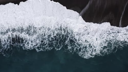 Ocean Waves Splash Into Sandy Beach