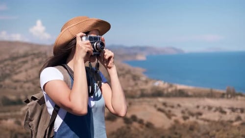 Woman Taking Pictures in Mountain Landscape