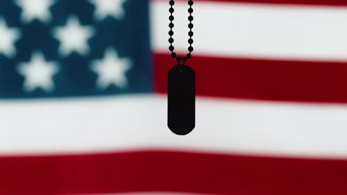Dog Tag Hanging in Front of American Flag