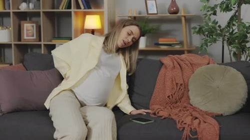 Exhausted Expectant Mother Suffering From Backache at Home