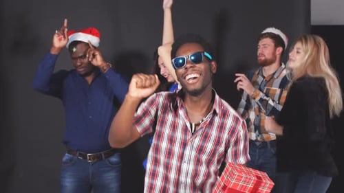 Festive Friends Dancing With Christmas Gifts