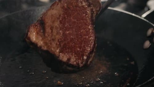 Beef Steak in a Frying Pan with Garlic Butter. Close Up Fatty Juicy South American Premium Beef